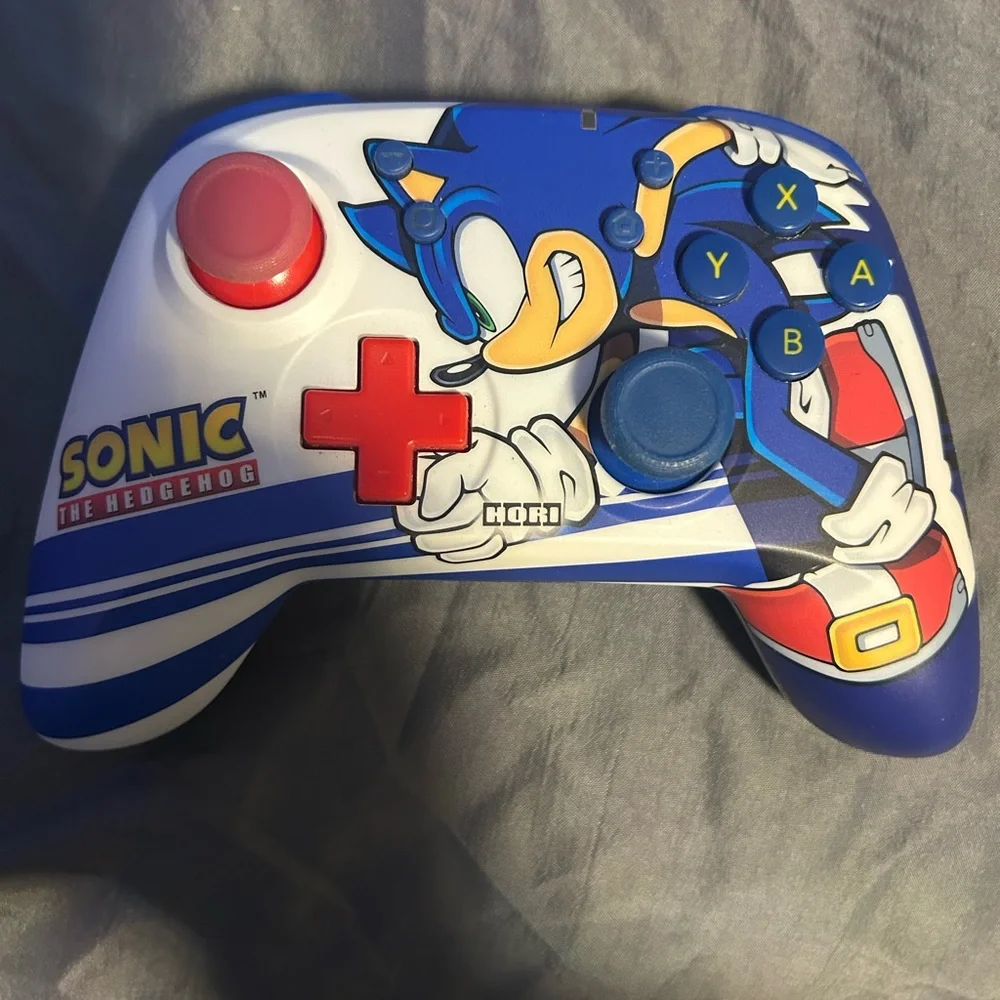 Nintendo Switch with gray Dock, Blue Kirby Case and Sonic Controller Accents,